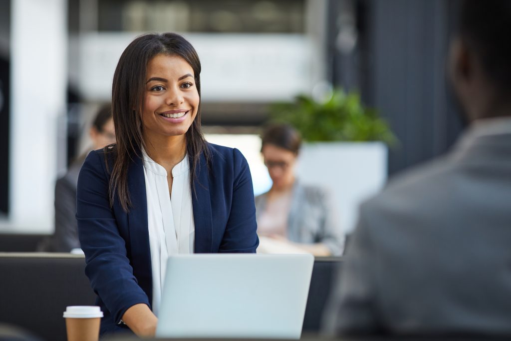 happy black woman meeting with business partner